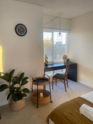 a bedroom with a desk and a chair and a table at Exclusive Private Room in the Shared Apartment by the Ocean in Los Angeles