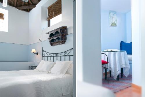 a bedroom with a bed and a table in a room at La Morada Mas Hermosa in Marbella