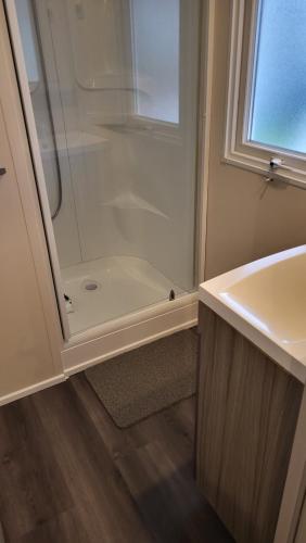 a white bathroom with a shower and a sink at Anne Marie Touzani in Boofzheim