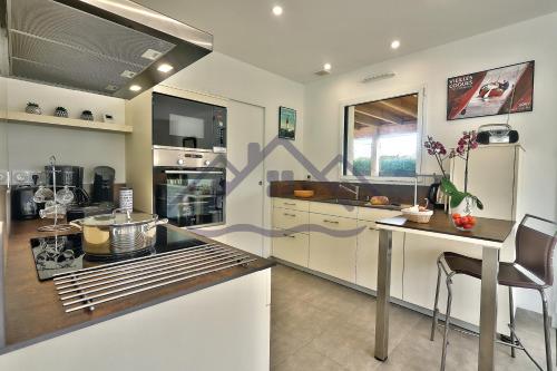 une cuisine avec des armoires blanches et un comptoir dans l'établissement LocaLise - M11 - Ty Gwennili - Maison de plain pied avec terrain entièrement clôturé - Accès plage et centre à pied - Wifi inclus - Draps inclus - Animaux non admis, au Guilvinec