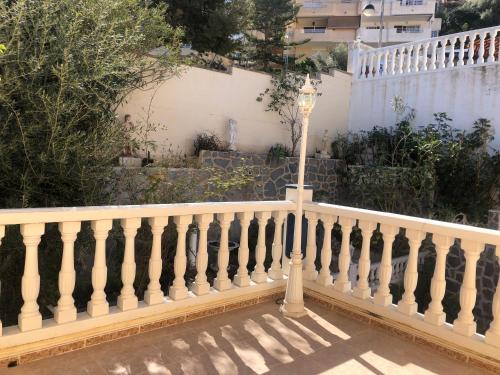 a white fence with a light pole on it at HOLIDAY CHALET BENIDORM in Benidorm