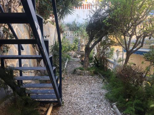 a gate leading to a garden with a stairway at HOLIDAY CHALET BENIDORM in Benidorm