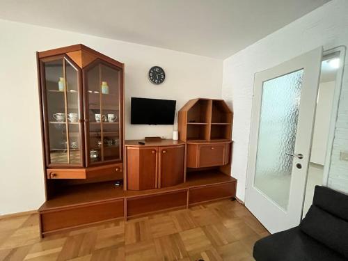 a living room with a tv and a entertainment center at Sweet Home Vienna 1 in Vienna