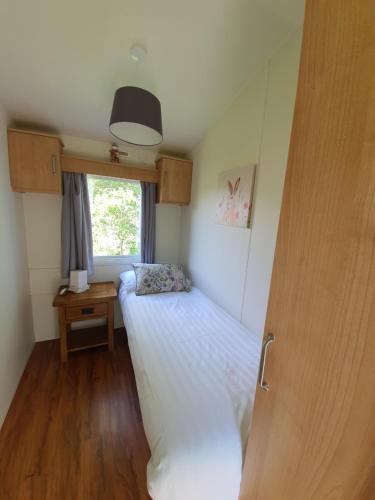 a small bedroom with a bed and a window at Howgill farm Bolton Abbey in Appletreewick