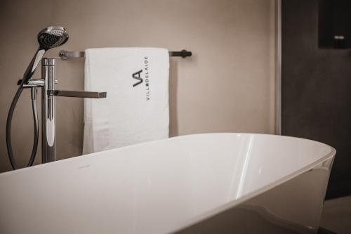 a bathroom with a white bath tub and a towel at Villa Adelaide Relais & Wine in Calamandrana