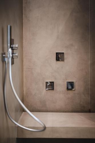 a shower with a hose in a bathroom at Villa Adelaide Relais & Wine in Calamandrana
