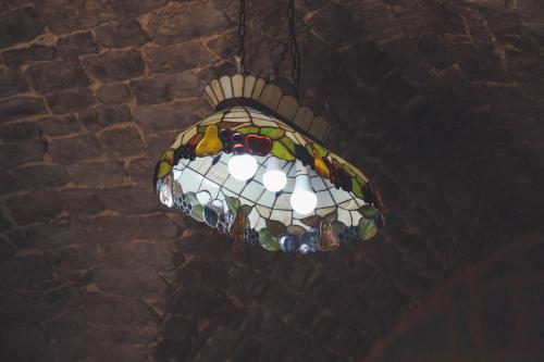 a stained glass chandelier hanging from a brick wall at Mandala in Mount מנדלה בחרמון סוויטה in Majdal Shams