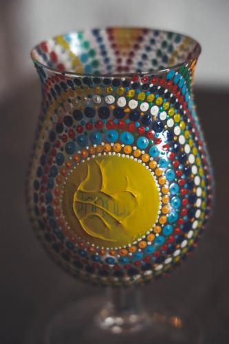 a colorful glass vase with a hand on it at Mandala in Mount מנדלה בחרמון סוויטה in Majdal Shams