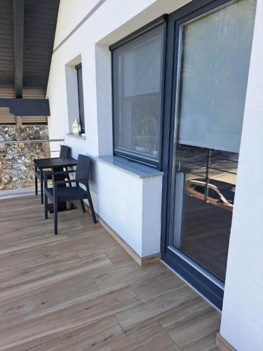 a balcony with a table and a window at Apartmaji Tisa in Žana in Rovte