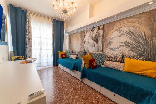 a living room with blue and yellow couch at Pisa Happy House in Pisa
