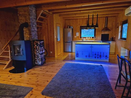 a large kitchen with a stove and a refrigerator at Mana Village - Jacuzzi & Sauna in Barłomino