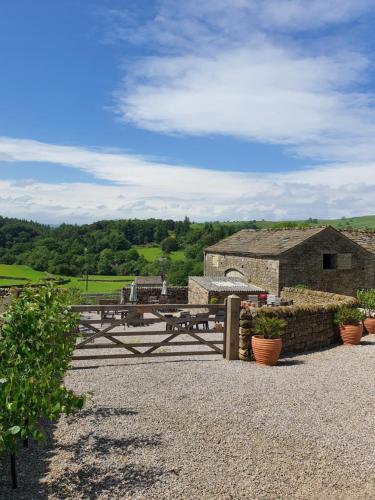 a picnic table in front of a stone building at Howgill farm Bolton Abbey in Appletreewick