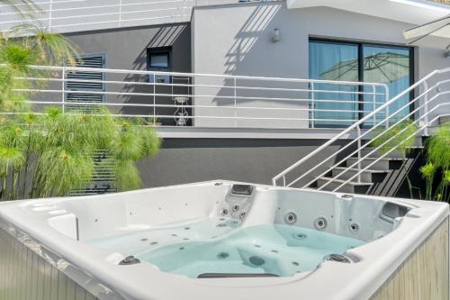 a bath tub on the balcony of a house at Studio 92, a Home in Madeira in Ponta do Sol