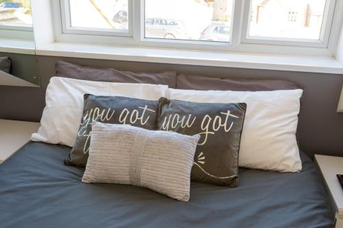 a bed with pillows and a pillow that says you got nowgot at Bradford on Avon in Bradford on Avon