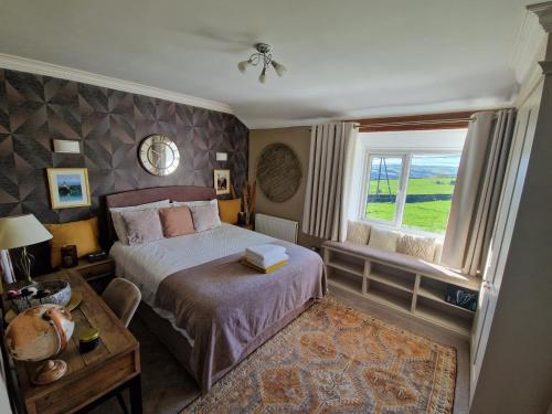 a bedroom with a bed and a window at Ryburn View Cottage in Luddenden Foot