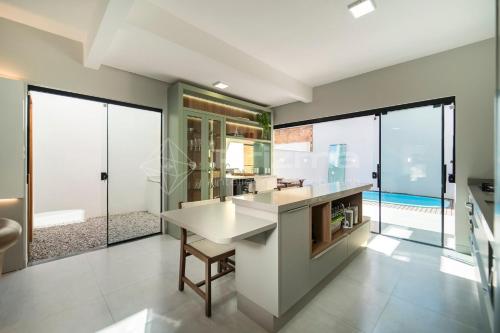 uma cozinha com grandes janelas e uma grande ilha de cozinha em Lindo duplex geminado na Praia de Mariscal. em Bombinhas