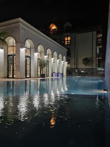 an empty swimming pool at night at RIVER Hotel & SPA in Călimăneşti