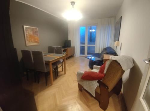 a living room with a table and a dining room at u cioci Lutki urocze mieszkanie z balkonem in Kraków