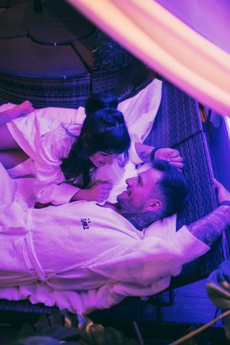 a man and a woman laying on a bed at Hotel Kotarz Spa&Wellness in Brenna