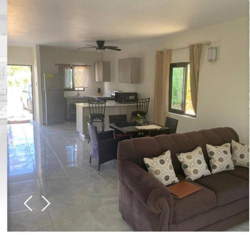a living room and kitchen with a couch and a table at 2 Bedroom House in Discovery Bay