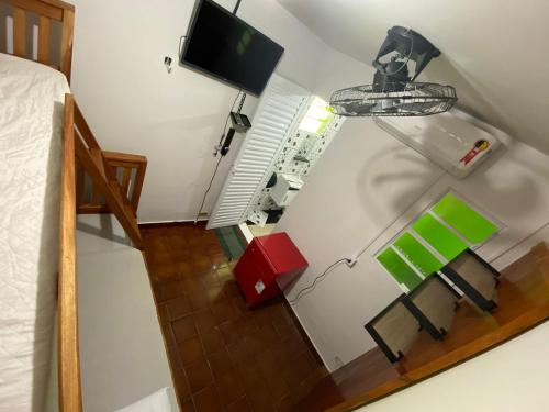 a room with a bed and a tv on a wall at Hostel Raizer in Campo Grande