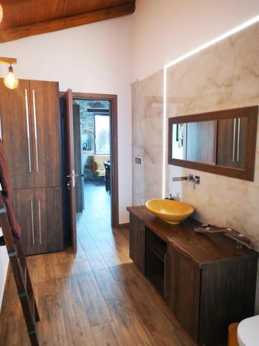 a bathroom with a sink and a mirror at Casa Romantica in Petriaí
