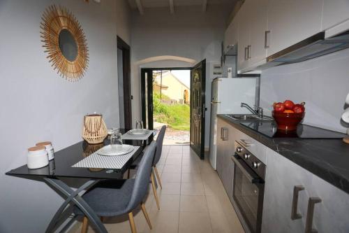 a kitchen with a table and a dining room at Fox Studio, Corfu in Alepou