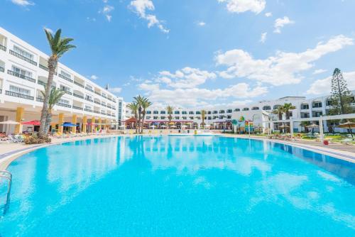 a large swimming pool in front of a building at Le Soleil Bella Vista - Couple and family only in Monastir