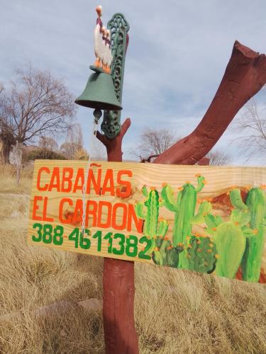 a sign for a caciendas el carton with a bell at El Cardón,monoambiente en el campo in Humahuaca