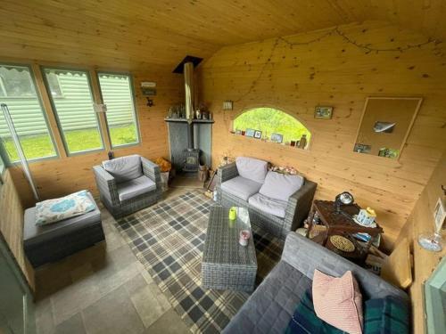 a living room with a couch and chairs and a fireplace at Pinetree Cottage, dog friendly, Holiday let, Callander Invertrossachs in Callander