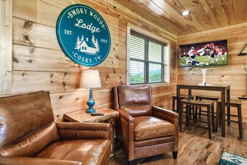 a living room with leather chairs and a sign in a cabin at Pet Friendly+ Hot Tub + Fire Pit + Game Room in Cosby