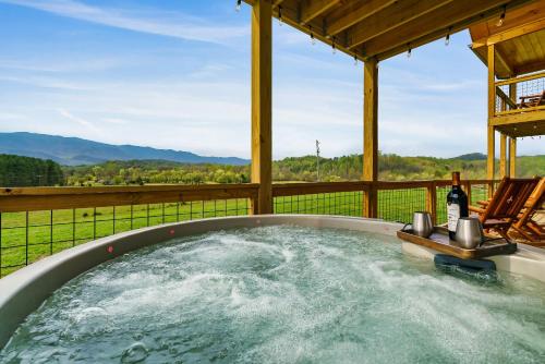 a jacuzzi tub with a view of a mountain at Pet Friendly+ Hot Tub + Fire Pit + Game Room in Cosby