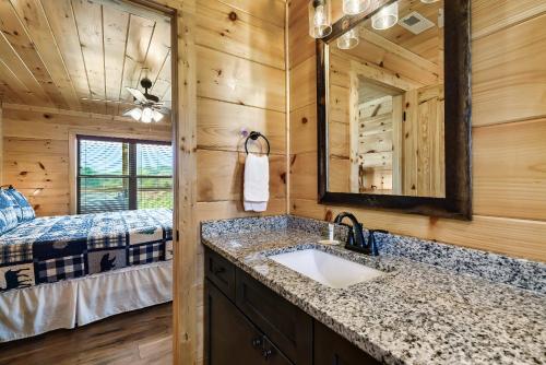 a bathroom with a sink in a log cabin at Pet Friendly+ Hot Tub + Fire Pit + Game Room in Cosby