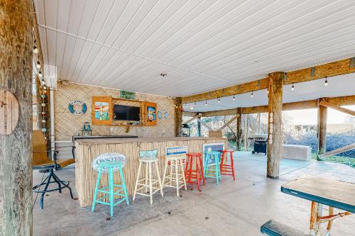 a kitchen with blue and red stools and a bar at Almost Heaven in St. George Island