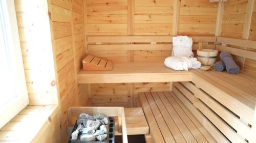 an inside of a sauna with a wooden floor at Pension & Seminarhaus "Haus am Fluss" in Laurenburg