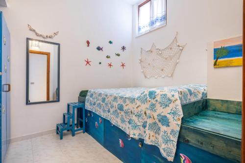 a bedroom with a bed and a table and a mirror at Villa Lilla in Villasimius