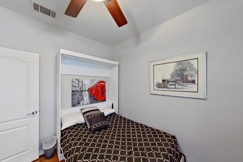 a bedroom with a bed and a ceiling fan at Tucumcari Treat in Austin