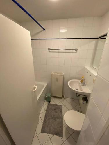 a white bathroom with a toilet and a sink at Schöne 2-Raumwohnung in Dresden in Dresden