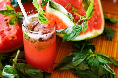 a drink in a glass with a slice of watermelon at Shaka Caye All inclusive Resort in Belize City