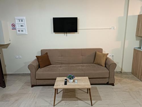 a living room with a couch and a coffee table at Savvas&Katia's luxury studio in Mantoúkion