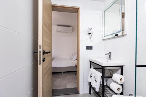 a bathroom with a sink and a mirror at Bodrum Vera Hotel in Bodrum City