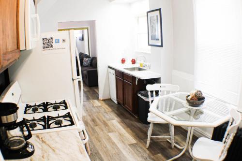 a kitchen with a stove and a sink and a table at 2 BR - Off Street Parking - Amazing View Nearby in Pittsburgh