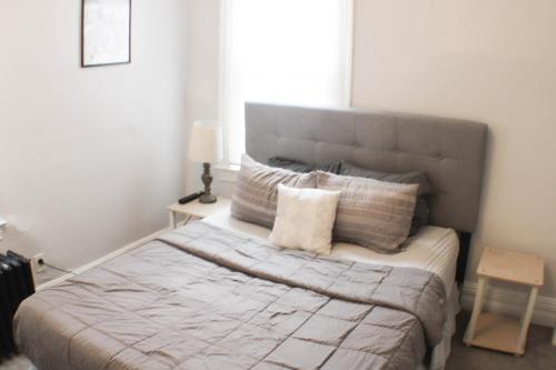 a bedroom with a large bed with pillows at 2 BR - Off Street Parking - Amazing View Nearby in Pittsburgh