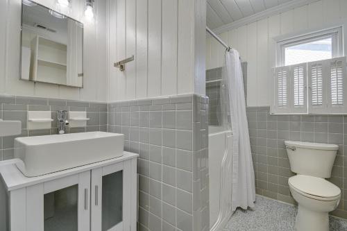 a bathroom with a toilet and a sink and a shower at Holden Beach Home on Intracoastal Waterway Canal! in Holden Beach