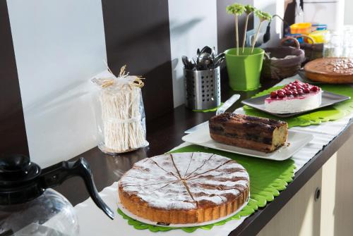 a table with a cake and other desserts on it at De Maria House in SantʼAgata sui Due Golfi