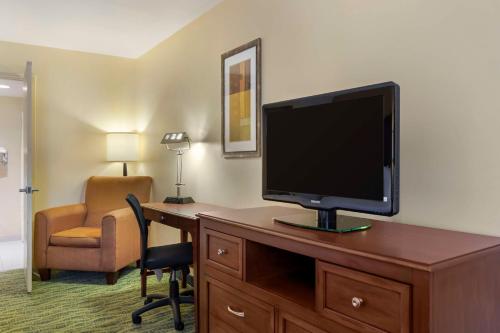 a hotel room with a desk with a television and a chair at Best Western McAllen Medical Center in McAllen