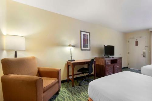 a hotel room with a bed and a desk and a chair at Best Western McAllen Medical Center in McAllen