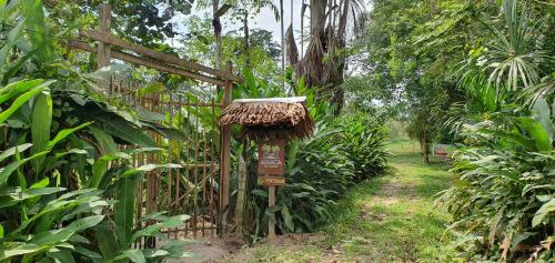a garden with a wooden gate and a path at Amaca Eco Station in Iquitos