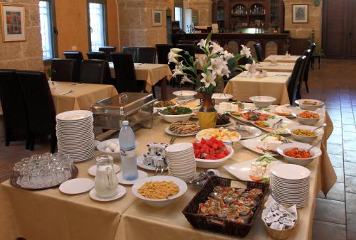 a long table with plates of food on it at Akkotel-Boutique hotel in ‘Akko