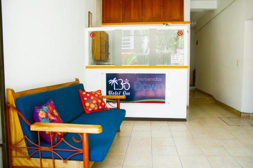 a blue chair with a pillow sitting in a room at Hotel OM DownTown in Santa Cruz Huatulco